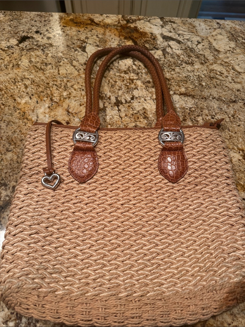Brighton Woven Straw Bag with Brown Leather Trim and braided handles.